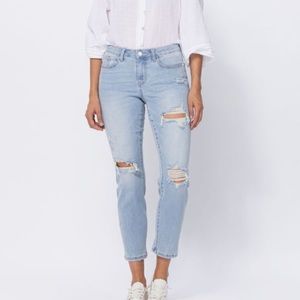 Mid Rise Judy Blue boyfriend jeans with pink stitching.